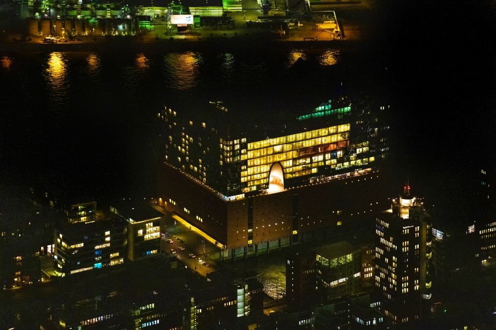 Aerial image at night Hamburg - Night lighting the Elbe Philharmonic Hall on the river bank of the Elbe in Hamburg