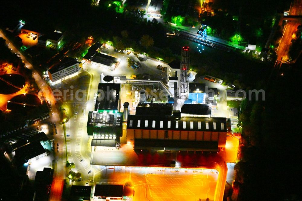 Aerial image at night Berlin - Night lighting power plants and exhaust towers of thermal power station BSR Muellheizkraftwerk Ruhleben on the Freiheit in Berlin