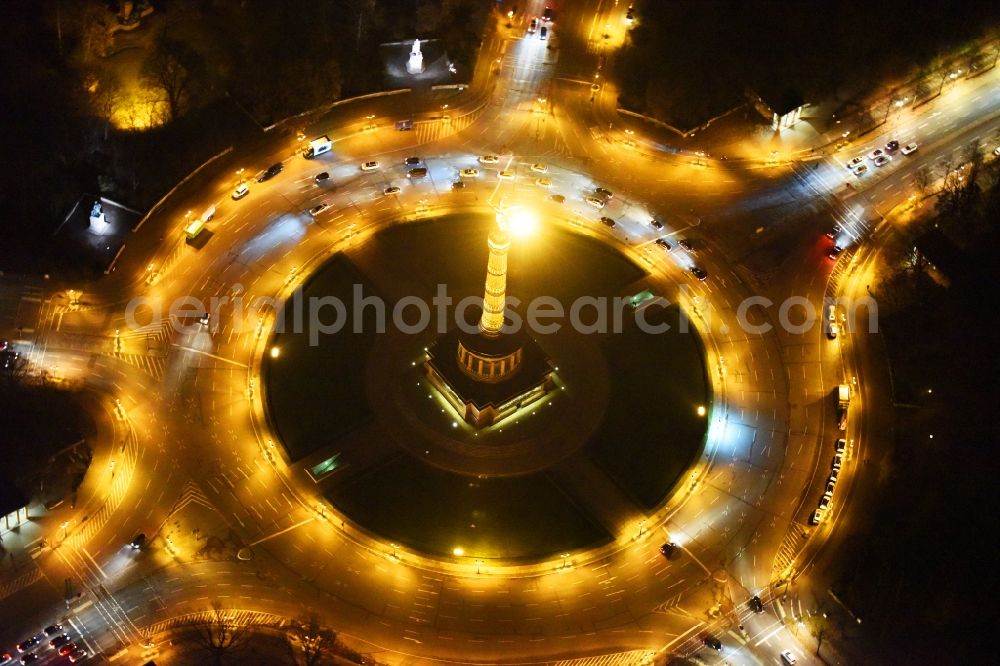Aerial photograph at night Berlin - Night view traffic management of the roundabout road at the Victory Column - Big Star in the park area of the Tiergarten in Berlin in Germany
