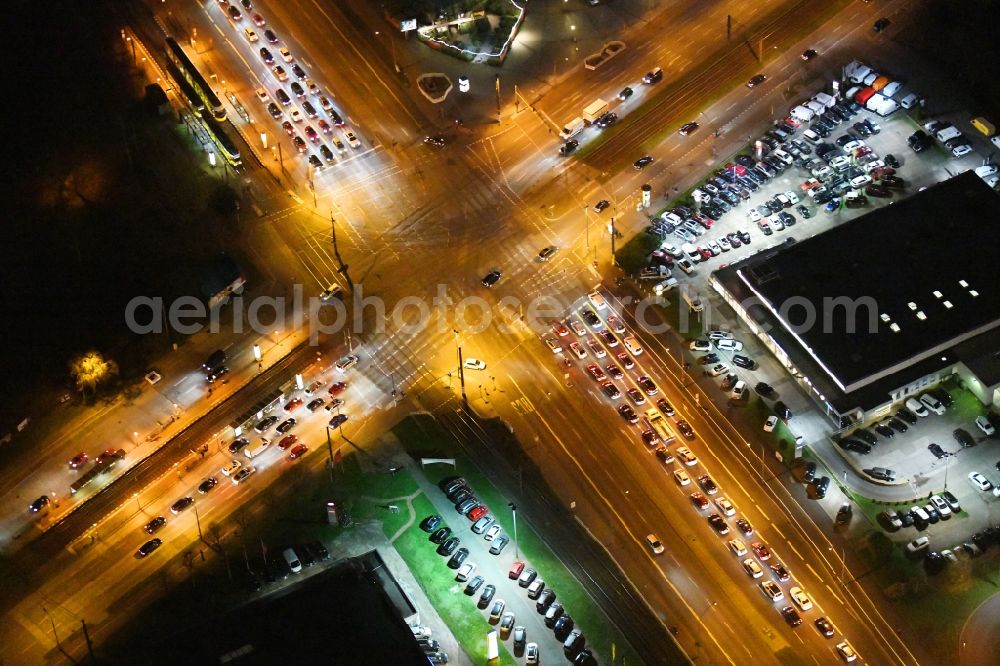 Berlin at night from above - Night lighting road over the crossroads Rhinstrasse corner Landsberger Allee in the district Marzahn in Berlin, Germany