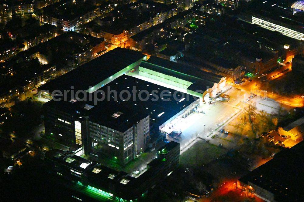 Aerial photograph at night Berlin - Night lighting warehouses and forwarding building of Amazon Transport GmbH - UDE6 in the district Reinickendorf in Berlin, Germany