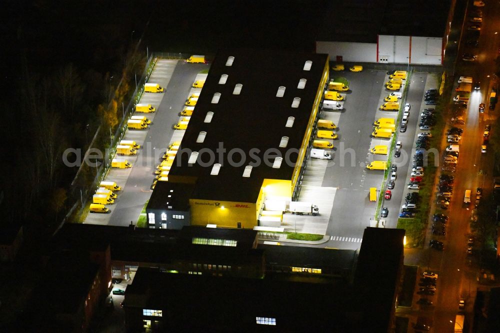 Berlin at night from above - Night lighting Warehouses and forwarding building DHL Delivery Berlin Zentrum on Josef-Orlopp-Strasse in the district Lichtenberg in Berlin, Germany