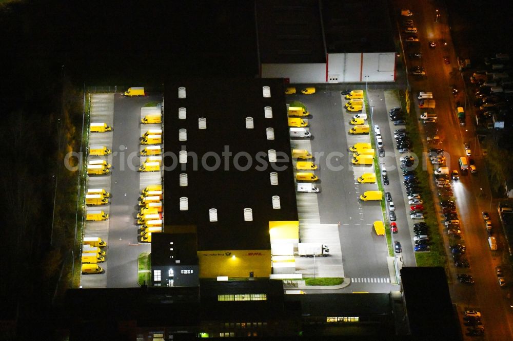 Berlin at night from the bird perspective: Night lighting Warehouses and forwarding building DHL Delivery Berlin Zentrum on Josef-Orlopp-Strasse in the district Lichtenberg in Berlin, Germany