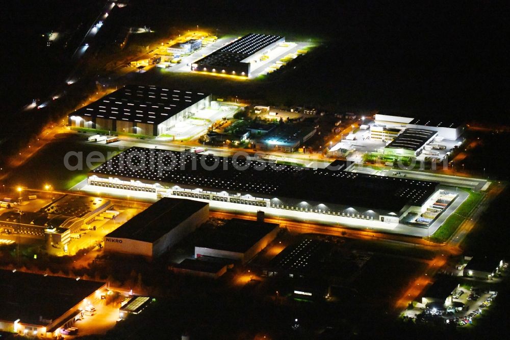 Aerial image at night Radeburg - Night lighting warehouses and forwarding building Lidl Zentrallager on Guerickestrasse in Radeburg in the state Saxony, Germany