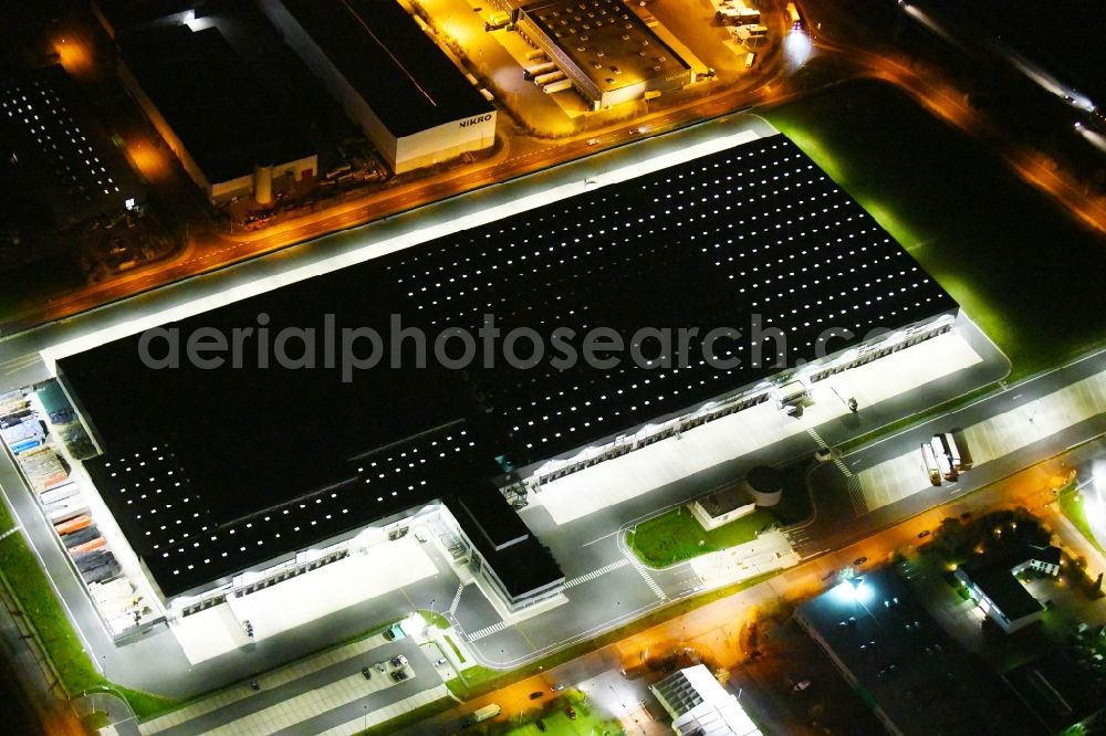 Aerial photograph at night Radeburg - Night lighting warehouses and forwarding building Lidl Zentrallager on Guerickestrasse in Radeburg in the state Saxony, Germany