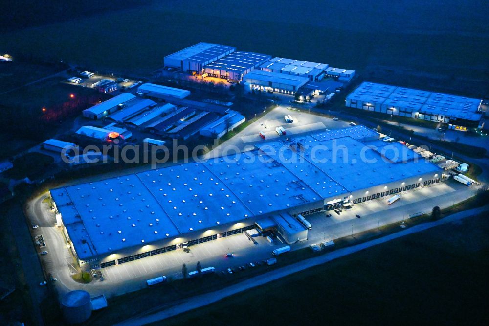 Kremmen at night from above - Night lighting warehouse complex-building in the industrial area of Lidl Vertriebs-GmbH & Co. KG on street Am Elsholz in Kremmen in the state Brandenburg, Germany