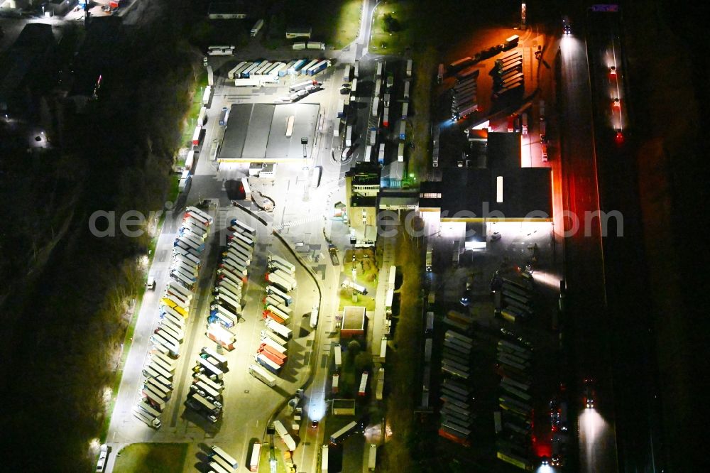 Aerial image at night Deubachshof - Night lighting lorries - parking spaces at the highway rest stop and parking of the BAB A 4 in Deubachshof in the state Thuringia, Germany