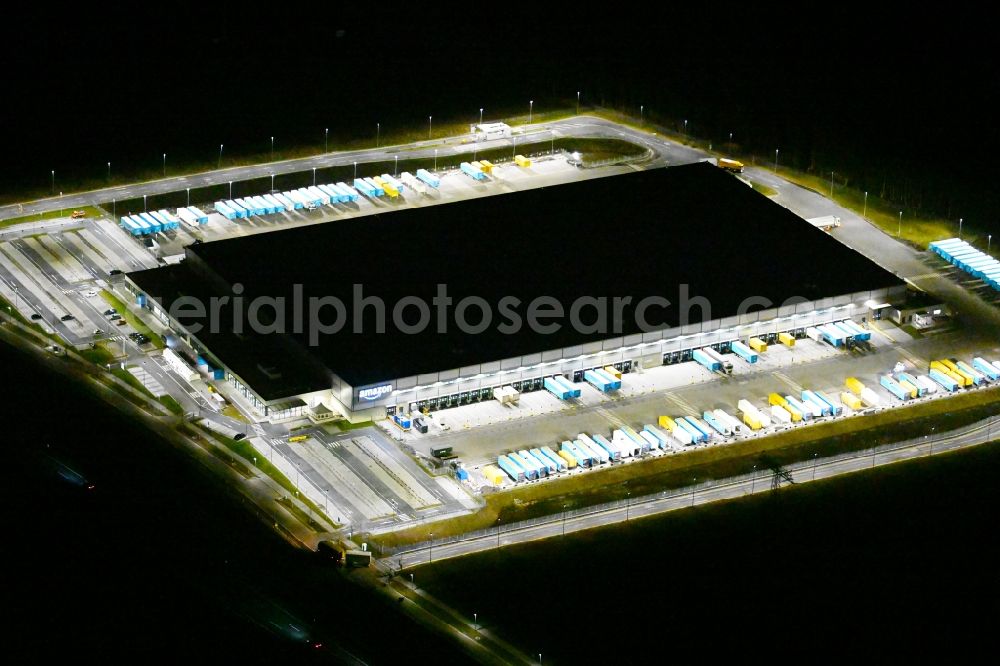 Aerial image at night Kiekebusch - Night lighting logistics center of the Achim Walder retailer Amazon in Kiekebusch in the state of Brandenburg, Germany