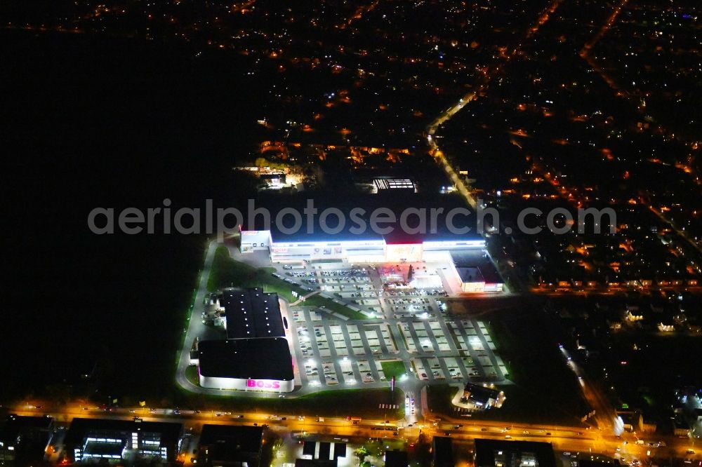 Aerial image at night Berlin - Night lighting site for the new building home-center of the Porta-Group at Pilgramer street in the district Mahlsdorf in Berlin
