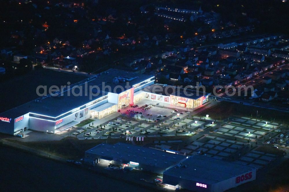 Aerial photograph at night Berlin - Night lighting site for the new building home-center of the Porta-Group at Pilgramer street in the district Mahlsdorf in Berlin