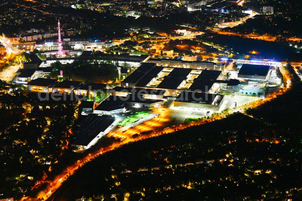 Berlin at night from above - Night lighting exhibition grounds and exhibition halls on Funkturm - Messedamm - Kongresszentrum ICC and the highway and motorway crosssing A100 to A115 in the district Charlottenburg in Berlin, Germany