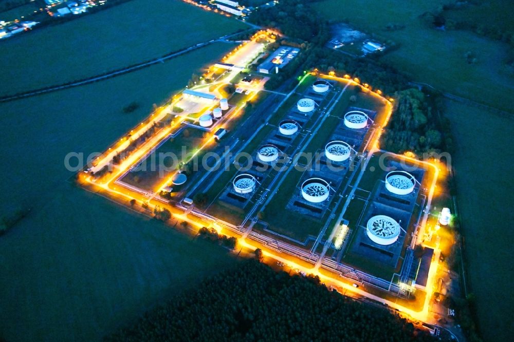 Aerial image at night Seefeld-Löhme - Night lighting mineral oil - high storage tanks for gasoline and diesel fuels in Seefeld in Brandenburg