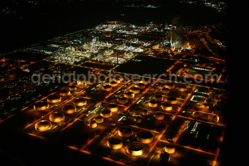 Aerial image at night Leuna - Night lighting mineral oil - tank of TOTAL Raffinerie Mitteldeutschland in Leuna in the state Saxony-Anhalt, Germany