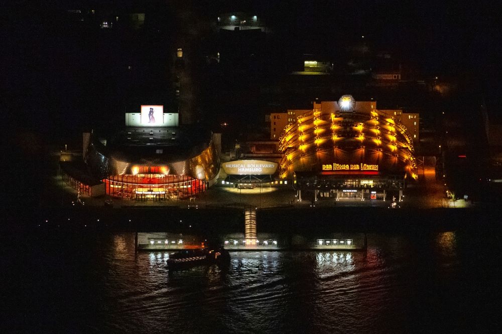 Hamburg at night from the bird perspective: Night lighting Musical Theatre, Stage entertainment on the banks of the Elbe in Hamburg Steinwerder