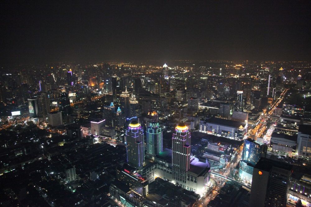 Aerial photograph at night Bangkok - Night view of the illuminated roof domes of high-rise towers of Pratunam Shopping Center in the center of the city of Bangkok in Thailand