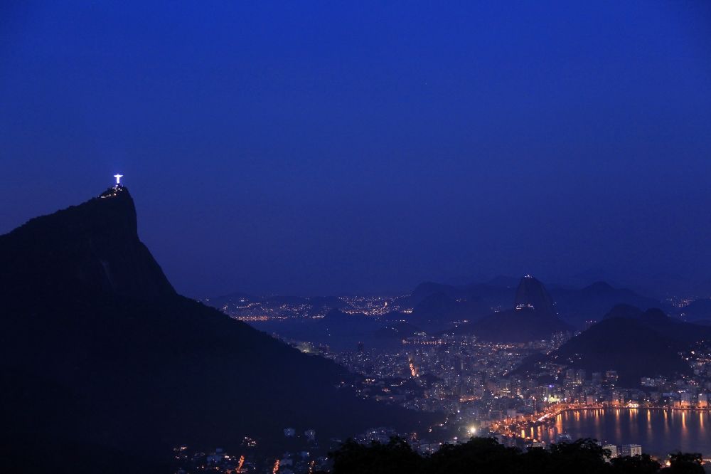 Rio de Janeiro at night from above - Night view Statue of Christ the Redeemer on Corcovado Mountain in the Tijuca forest in Rio de Janeiro in Brazil