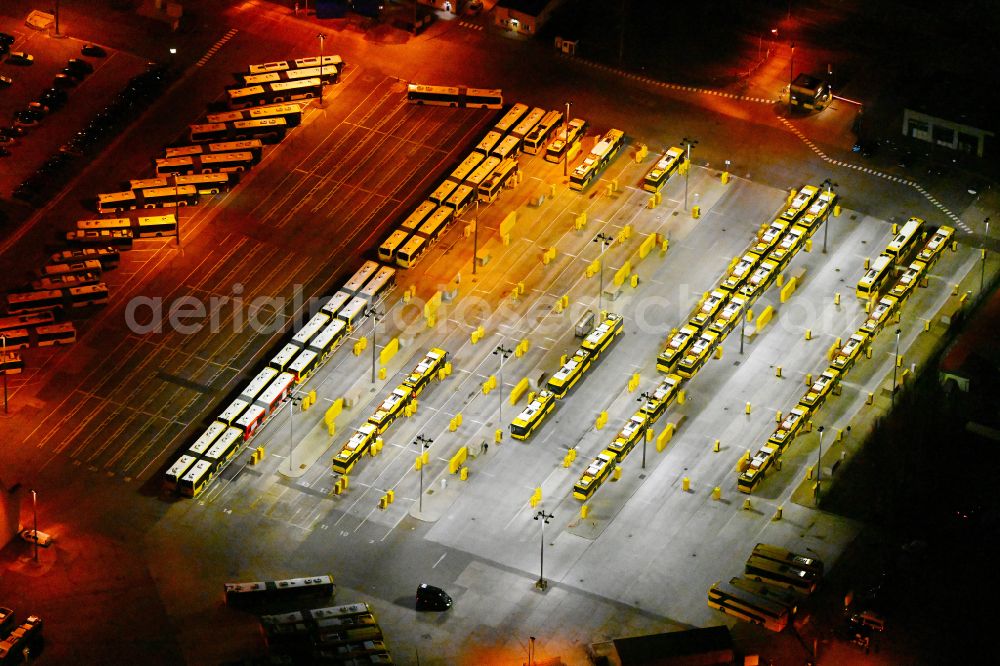 Aerial photograph at night Berlin - Night lighting depot of the Municipal Transport Company on Indira-Gandhi-Strasse in the district Hohenschoenhausen in Berlin, Germany