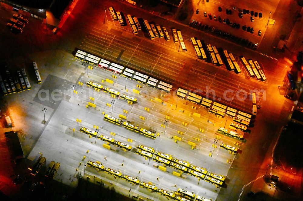 Berlin at night from the bird perspective: Night lighting depot of the Municipal Transport Company on Indira-Gandhi-Strasse in the district Hohenschoenhausen in Berlin, Germany
