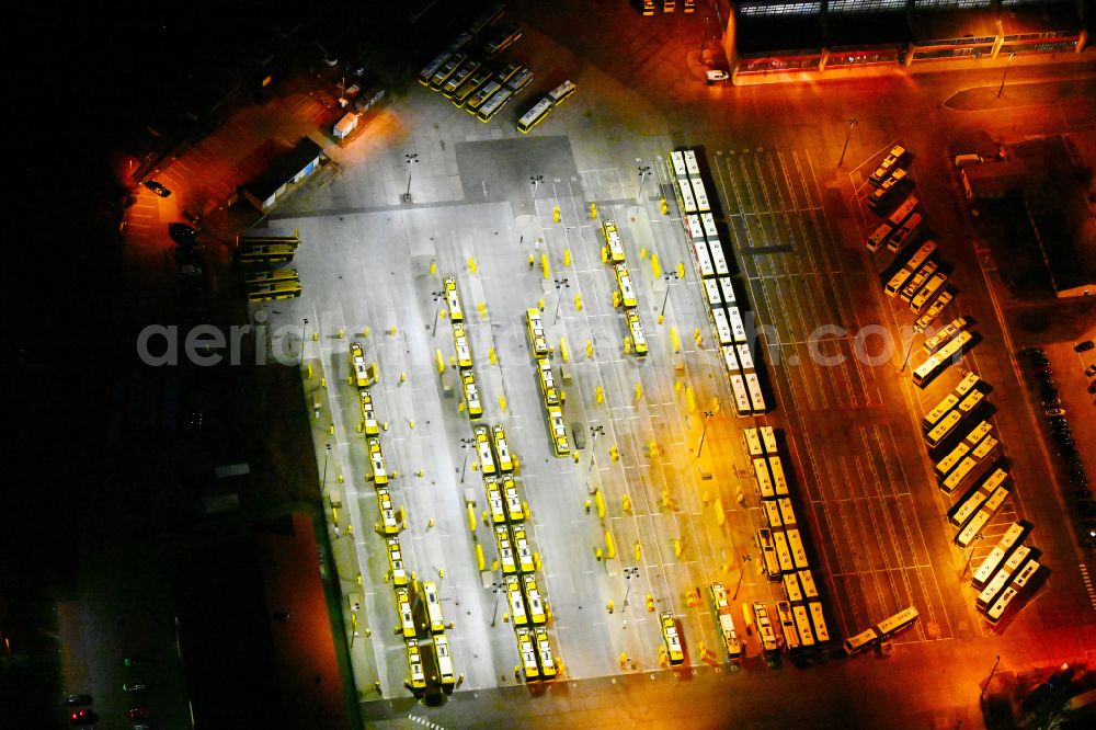 Aerial image at night Berlin - Night lighting depot of the Municipal Transport Company on Indira-Gandhi-Strasse in the district Hohenschoenhausen in Berlin, Germany