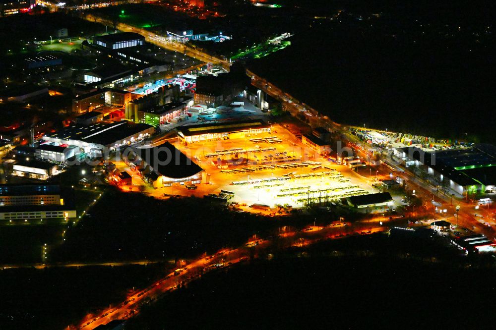 Aerial image at night Berlin - Night lighting depot of the Municipal Transport Company on Indira-Gandhi-Strasse in the district Hohenschoenhausen in Berlin, Germany