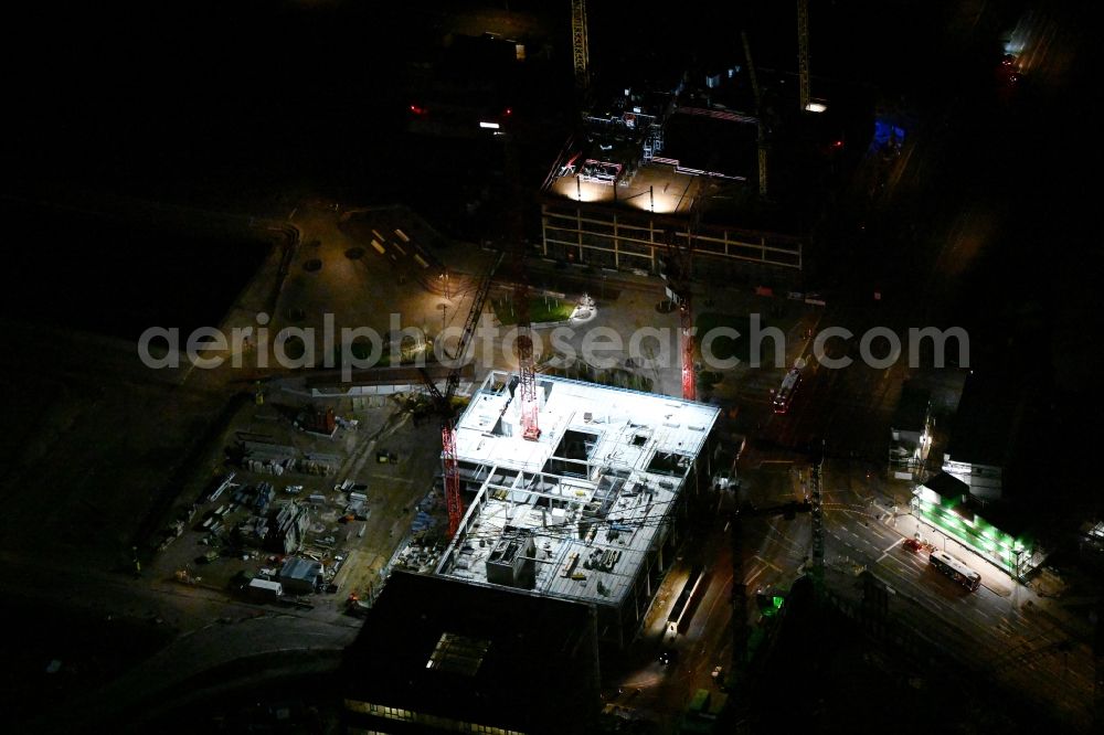 Aerial image at night Hamburg - Night lighting construction site to build a new office and commercial building EDGE ElbSide on place Amerigo-Vespucci-Platz in the district HafenCity in Hamburg, Germany