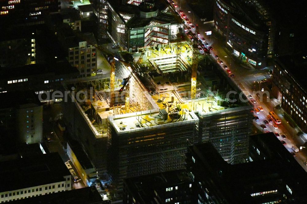 Hamburg at night from above - Night lighting construction site to build a new office and commercial building of Olympus Campus on Heidenkonpsweg - Wendenstrasse in Hamburg, Germany