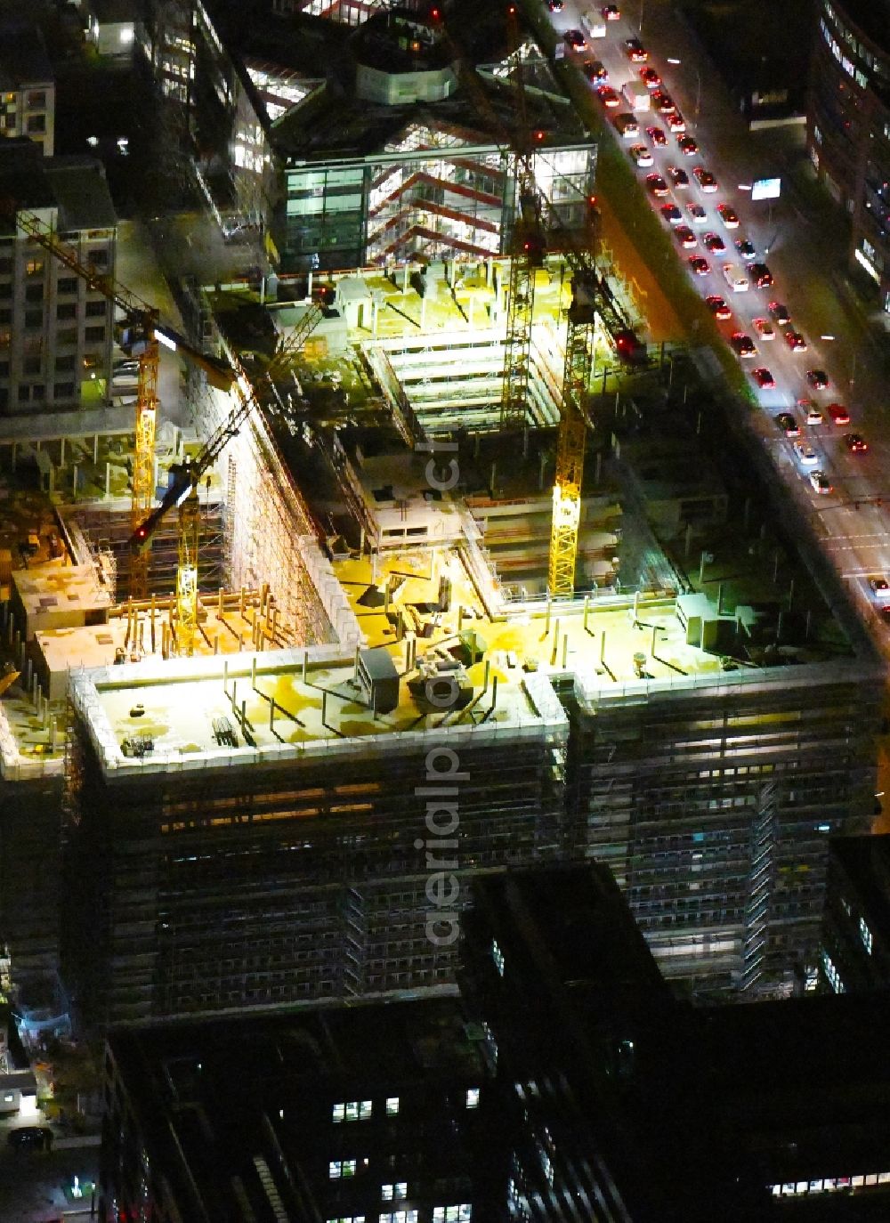 Aerial photograph at night Hamburg - Night lighting construction site to build a new office and commercial building of Olympus Campus on Heidenkonpsweg - Wendenstrasse in Hamburg, Germany