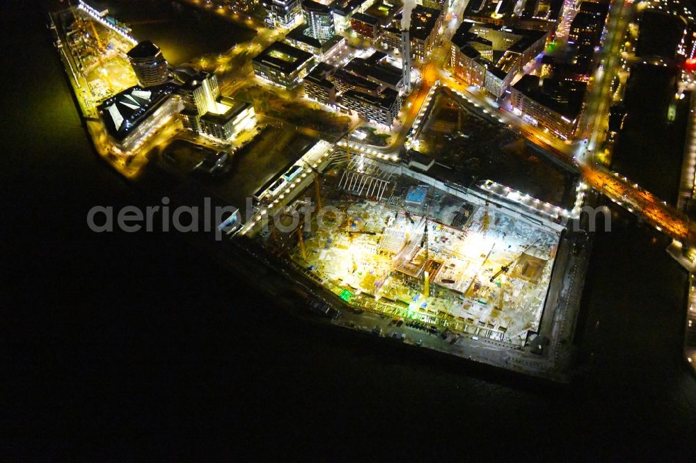 Hamburg at night from above - Night lighting construction site for the new building complex of the shopping center at Ueberseequartier at Chicagokai - Osakaallee in the area of the former Grasbrooks in the Hafencity district in Hamburg, Germany