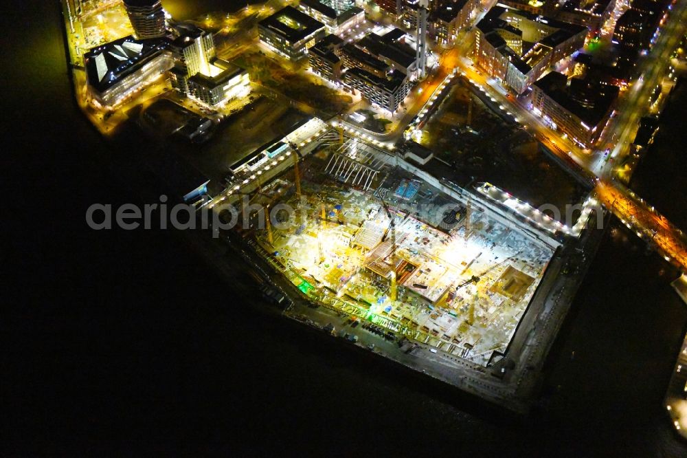Hamburg at night from the bird perspective: Night lighting construction site for the new building complex of the shopping center at Ueberseequartier at Chicagokai - Osakaallee in the area of the former Grasbrooks in the Hafencity district in Hamburg, Germany
