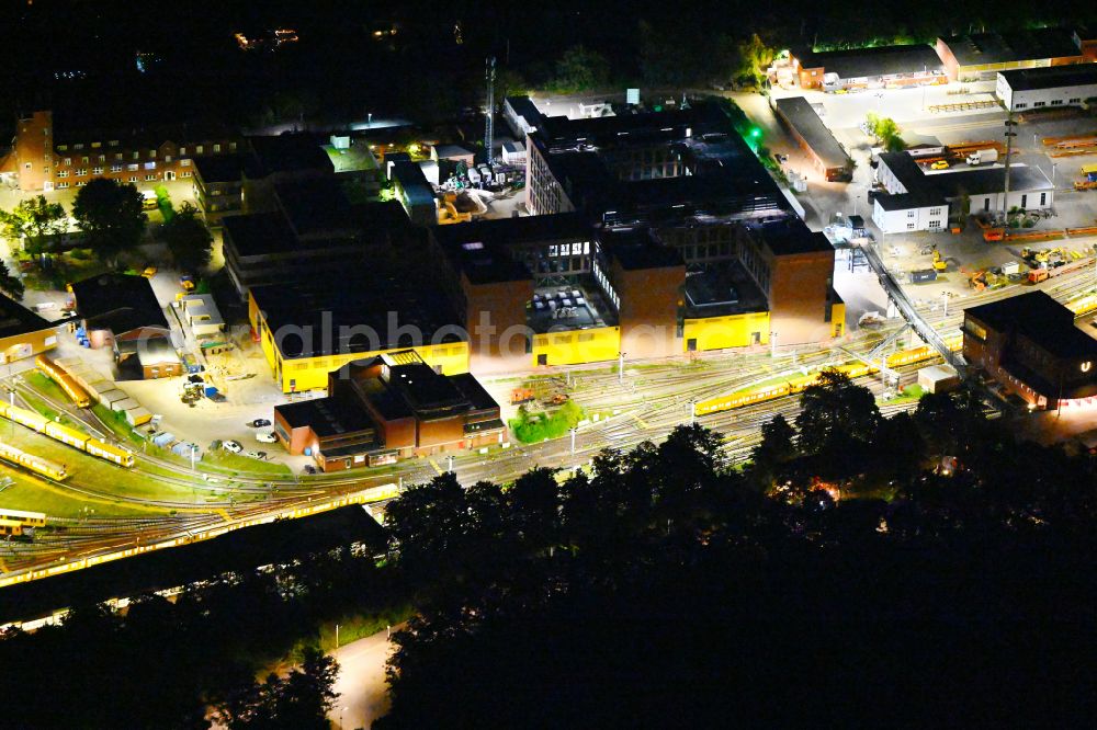 Berlin at night from the bird perspective: Night lighting railway depot and repair shop for maintenance and repair of trains the Berlin subway in the district Charlottenburg Westend in Berlin, Germany