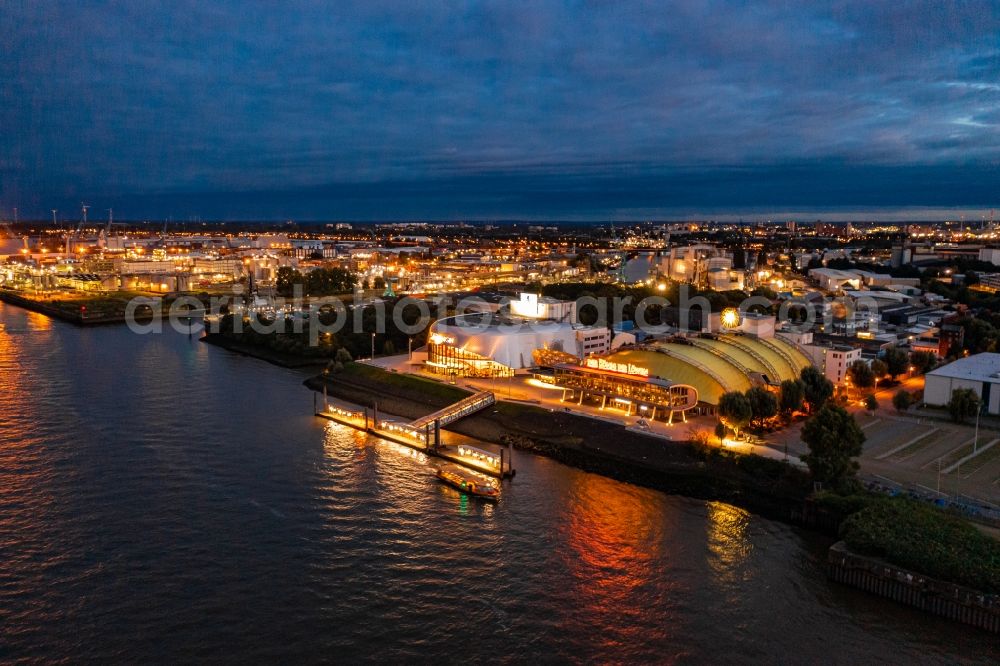 Aerial image at night Hamburg - Night lighting Building of the new Musical Theatre, Stage entertainment on the banks of the Elbe in the district Steinwerder in Hamburg Steinwerder