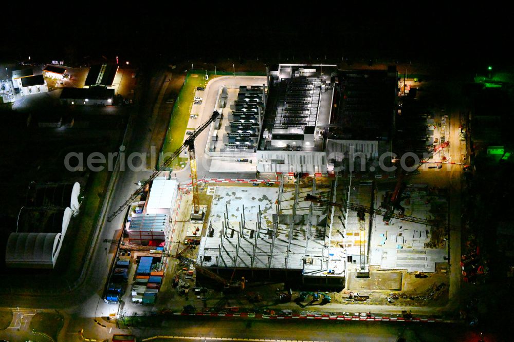 Aerial photograph at night Mittenwalde - Night lighting construction site of data center building and online data processing hub on street Dahmestrasse in Mittenwalde in the state Brandenburg, Germany