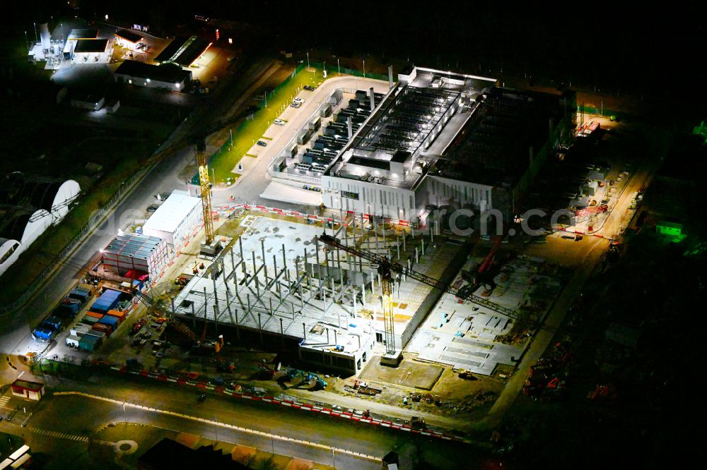 Aerial image at night Mittenwalde - Night lighting construction site of data center building and online data processing hub on street Dahmestrasse in Mittenwalde in the state Brandenburg, Germany