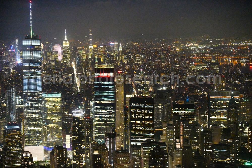Aerial photograph at night New York - Night lighting City center with One World Trade Center in the skyline in the downtown area in the district Manhattan in New York in United States of America