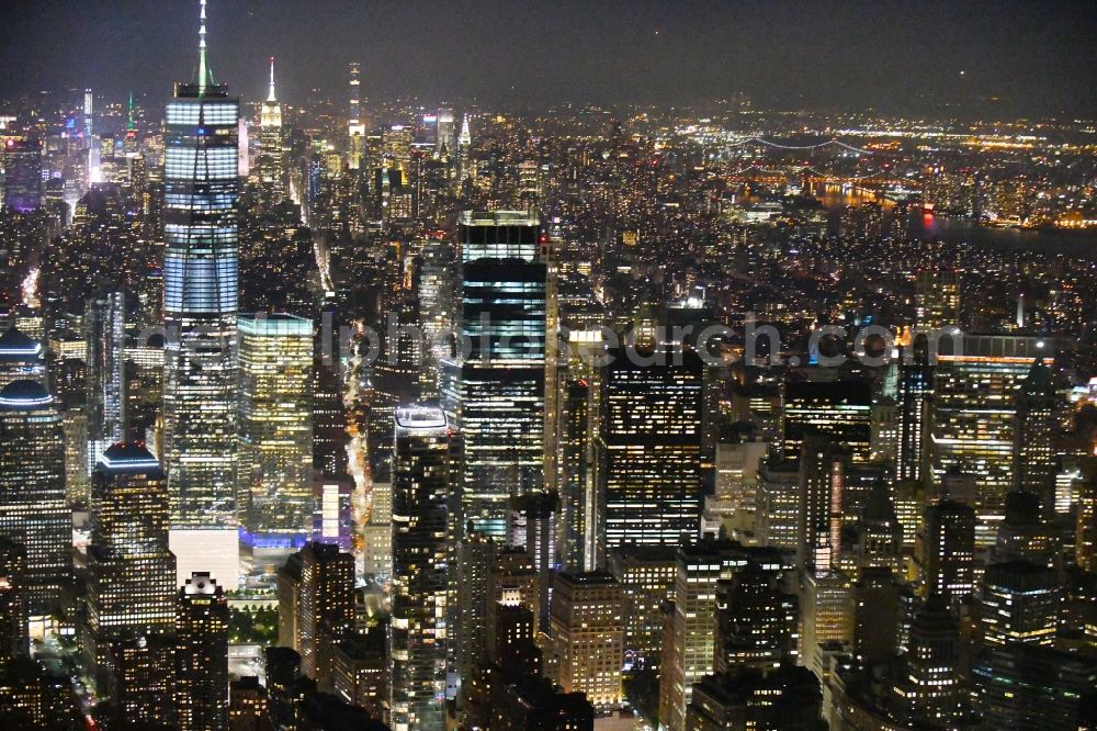 Aerial image at night New York - Night lighting City center with One World Trade Center in the skyline in the downtown area in the district Manhattan in New York in United States of America