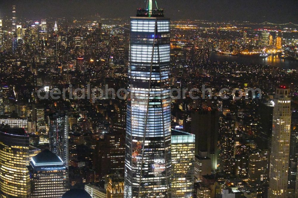 New York at night from the bird perspective: Night lighting City center with One World Trade Center in the skyline in the downtown area in the district Manhattan in New York in United States of America