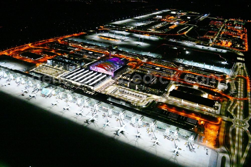 München-Flughafen at night from above - Night lighting dispatch building and terminals on the premises of the airport in Muenchen-Flughafen in the state Bavaria, Germany