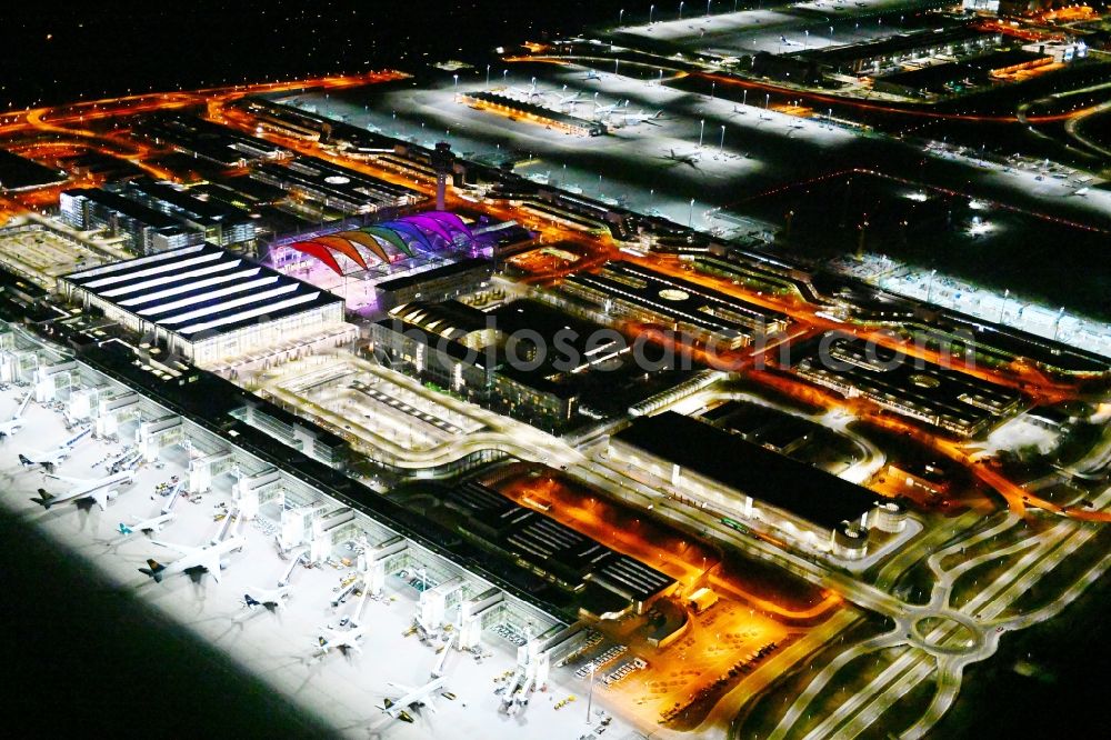 München-Flughafen at night from the bird perspective: Night lighting dispatch building and terminals on the premises of the airport in Muenchen-Flughafen in the state Bavaria, Germany