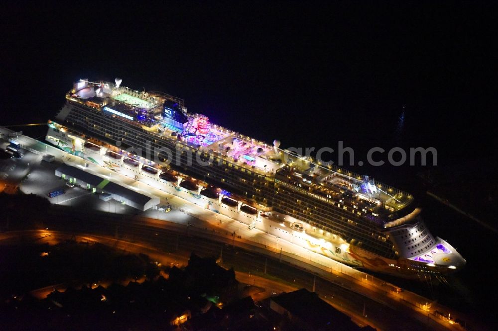 Rostock at night from the bird perspective: Night lighting Passenger ship Norwegian Getaway in the district Warnemuende in Rostock in the state Mecklenburg - Western Pomerania, Germany