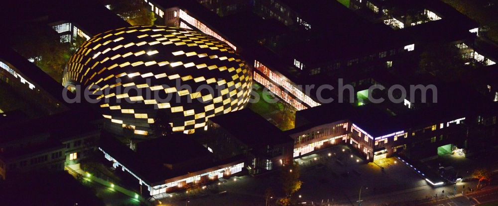 Aerial photograph at night Berlin Dahlem - Night view of the stepped illumination of the University Library of the Freie Universitaet Berlin. Designed by the architect Lord Norman Foster building resembles the shape of a brain and is already in advance, The Berlin Brain baptized. The library is located on the campus of FU in the district of Zehlendorf in Berlin