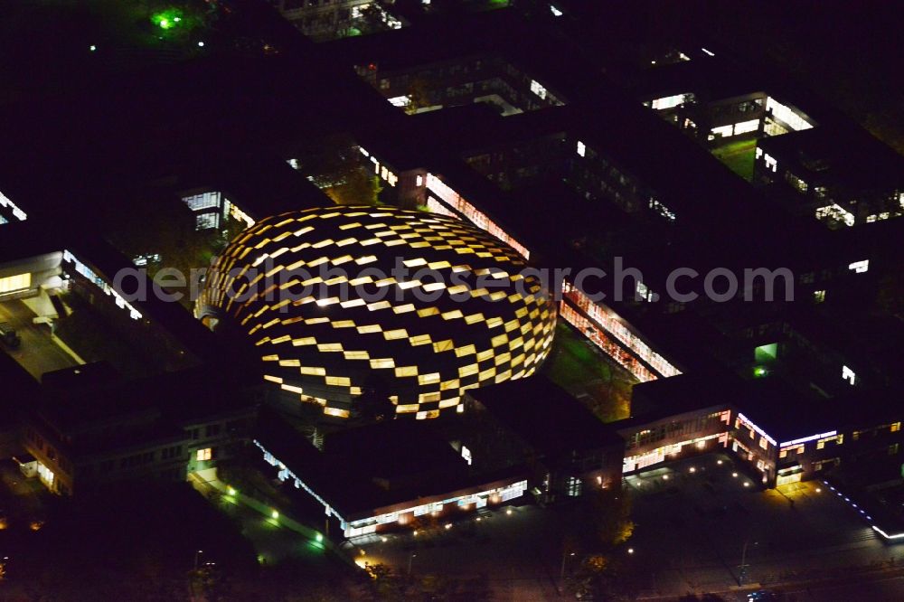 Aerial image at night Berlin Dahlem - Night view of the stepped illumination of the University Library of the Freie Universitaet Berlin. Designed by the architect Lord Norman Foster building resembles the shape of a brain and is already in advance, The Berlin Brain baptized. The library is located on the campus of FU in the district of Zehlendorf in Berlin