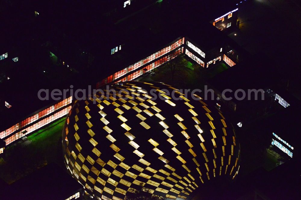 Aerial image at night Berlin Dahlem - Night view of the stepped illumination of the University Library of the Freie Universitaet Berlin. Designed by the architect Lord Norman Foster building resembles the shape of a brain and is already in advance, The Berlin Brain baptized. The library is located on the campus of FU in the district of Zehlendorf in Berlin