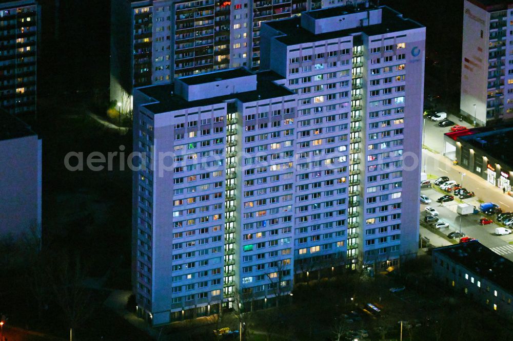 Aerial image at night Berlin - Night lighting skyscrapers in the residential area of industrially manufactured settlement with Aussichtsplattform degewo- Skywalk on street Raoul-Wallenberg-Strasse in the district Marzahn in Berlin, Germany