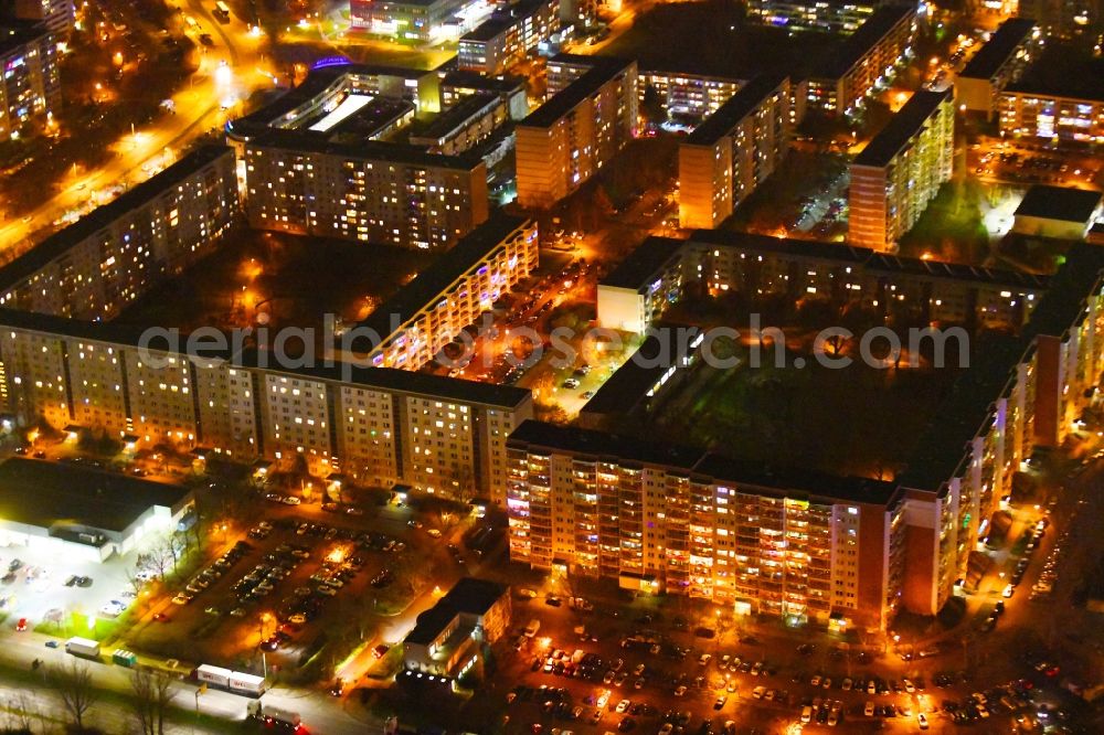 Aerial image at night Berlin - Night lighting skyscrapers in the residential area of industrially manufactured settlement along the Walter-Felsenstein-Strasse - Mehrower Allee in the district Marzahn in Berlin, Germany