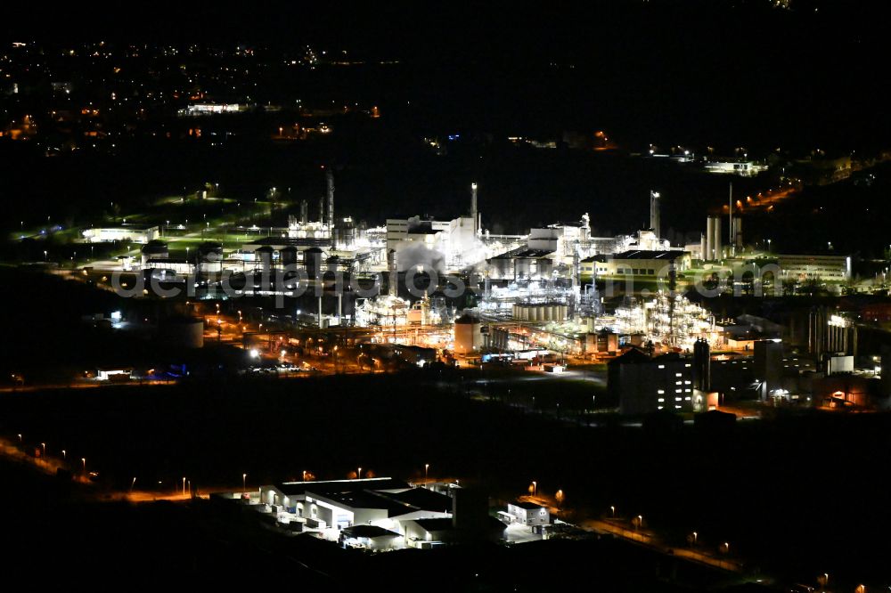 Elsteraue at night from above - Night lighting Refinery equipment and management systems on the factory premises of the chemical manufacturers Chemie- and Industriepark Zeitz in Elsteraue in the state Saxony-Anhalt, Germany