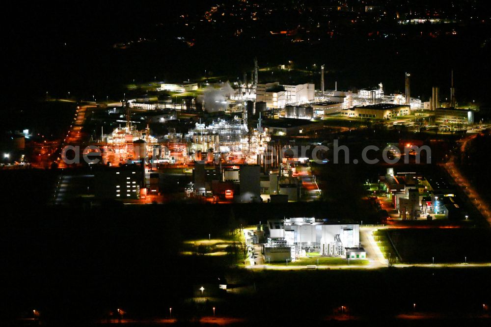 Elsteraue at night from above - Night lighting Refinery equipment and management systems on the factory premises of the chemical manufacturers Chemie- and Industriepark Zeitz in Elsteraue in the state Saxony-Anhalt, Germany