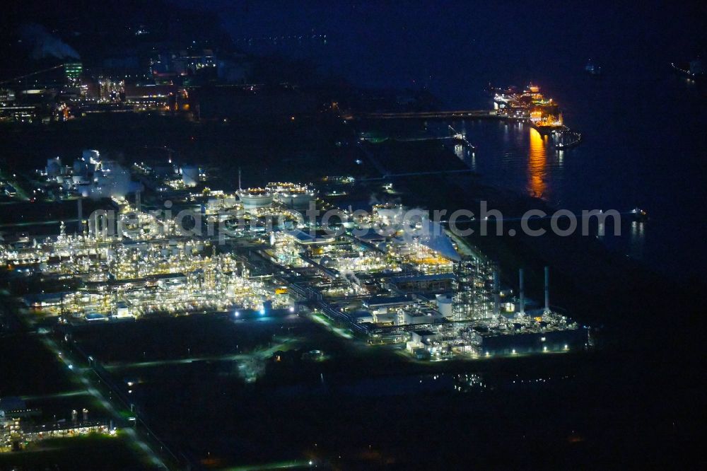 Aerial photograph at night Stade - Night lighting refinery equipment and management systems on the factory premises of the chemical manufacturers of Fa. Dow Chemical Olin in Stade in the state Lower Saxony, Germany