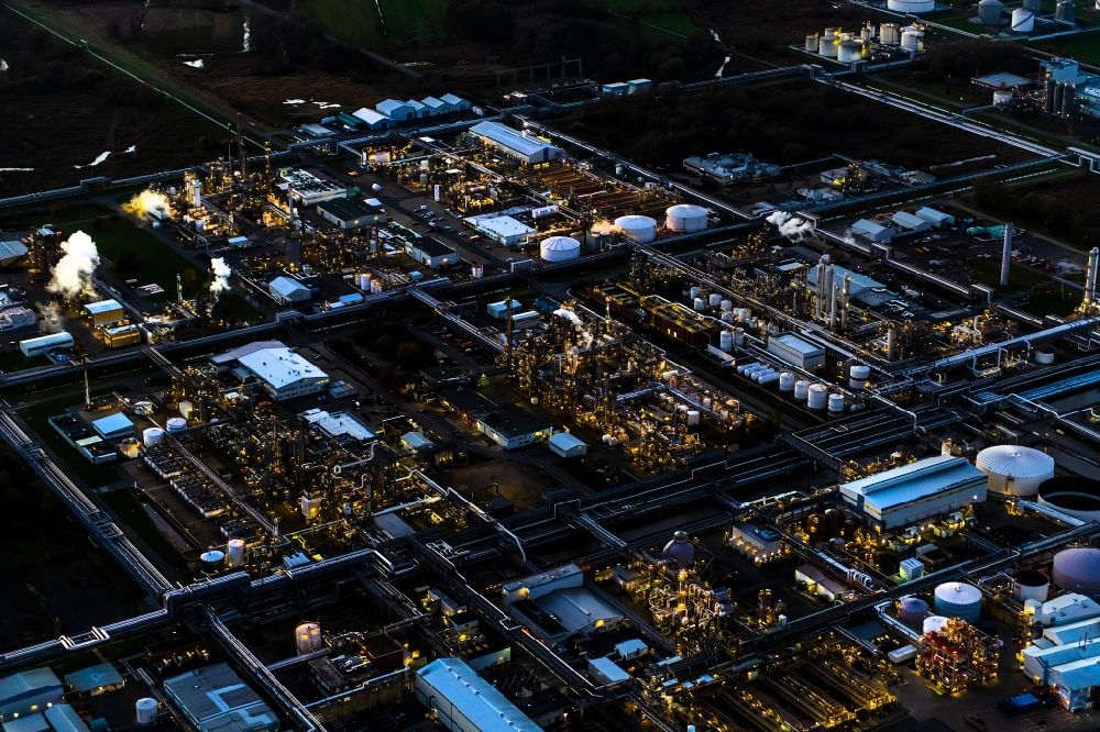 Stade at night from the bird perspective: Night lighting refinery equipment and management systems on the factory premises of the chemical manufacturers of Fa. Dow Chemical Olin in Stade in the state Lower Saxony, Germany