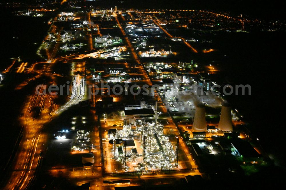 Aerial photograph at night Leuna - Night lighting refinery equipment and management systems on the factory premises of the chemical manufacturers on street Strasse der OdF in the district Spergau in Leuna in the state Saxony-Anhalt, Germany