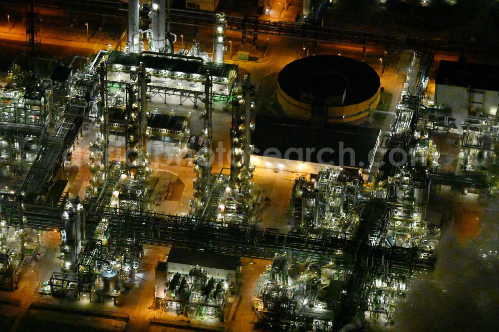Aerial image at night Leuna - Night lighting refinery equipment and management systems on the factory premises of the chemical manufacturers on street Strasse der OdF in the district Spergau in Leuna in the state Saxony-Anhalt, Germany